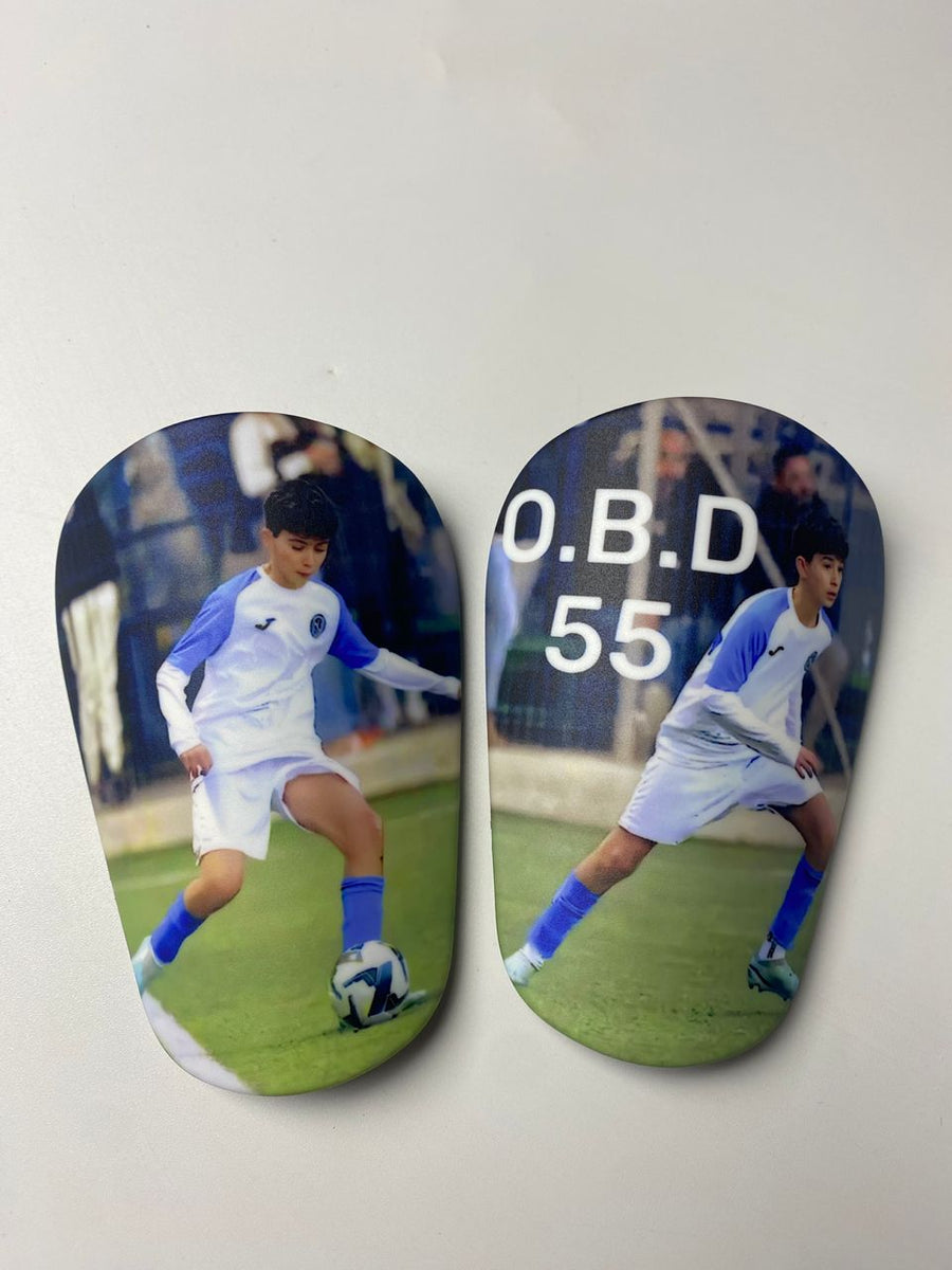 Custom shin guards with a young player photo and O.B.D 55