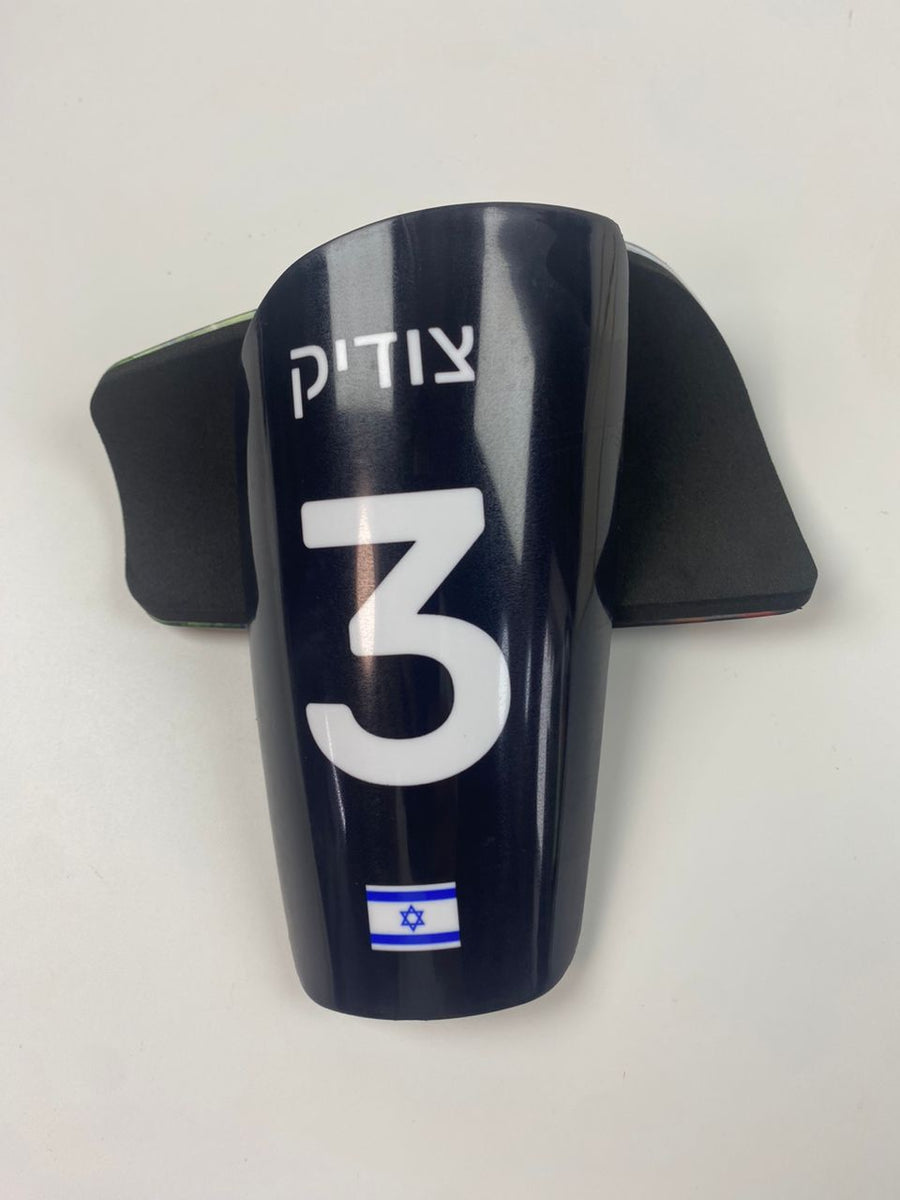 Custom shin guards with a Hebrew name, number 3, and Israeli flag