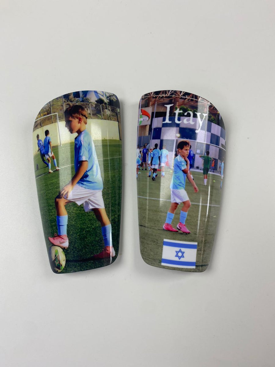 Custom shin guards with Itay player photos and an Israeli flag