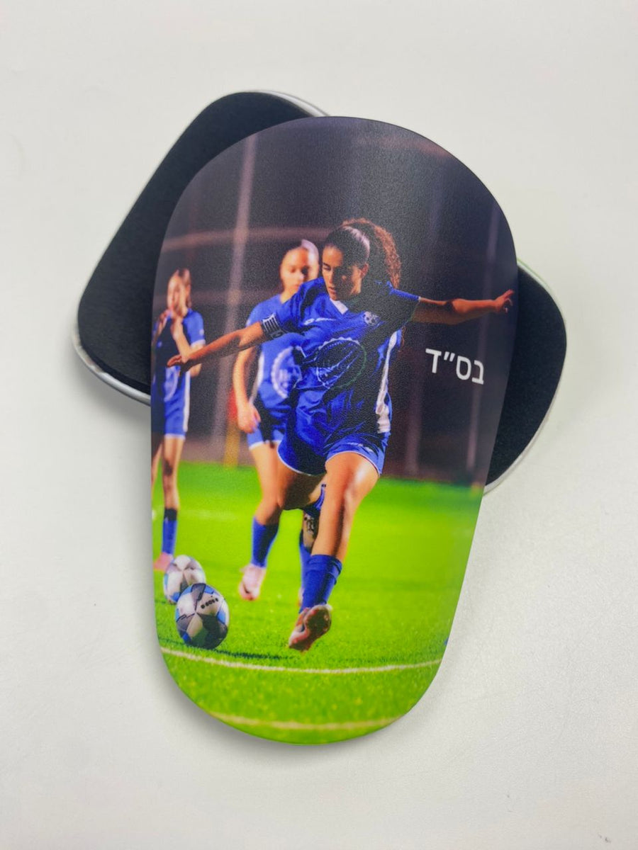 Custom shin guards with a women's soccer action photo and Hebrew dedication
