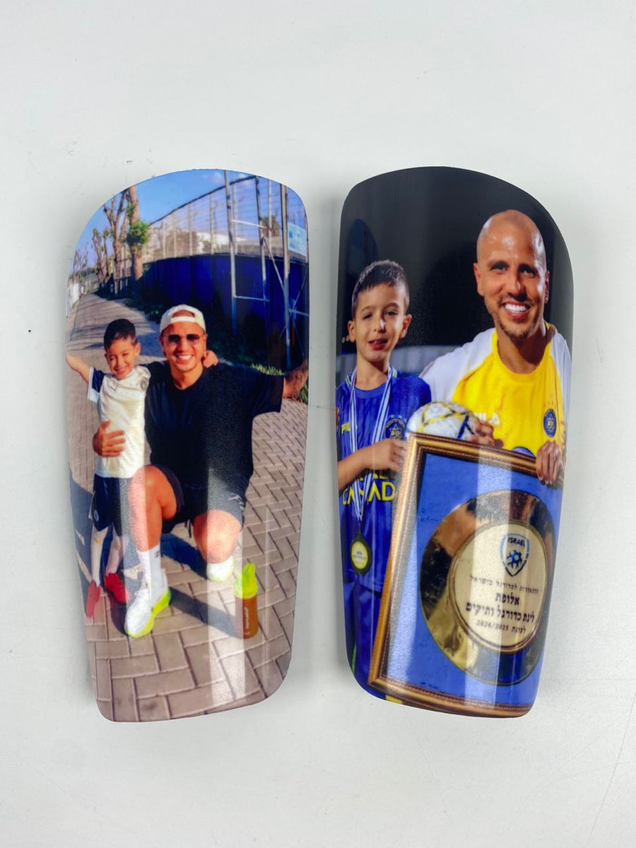 Custom shin guards with father-and-son photos and a championship plaque